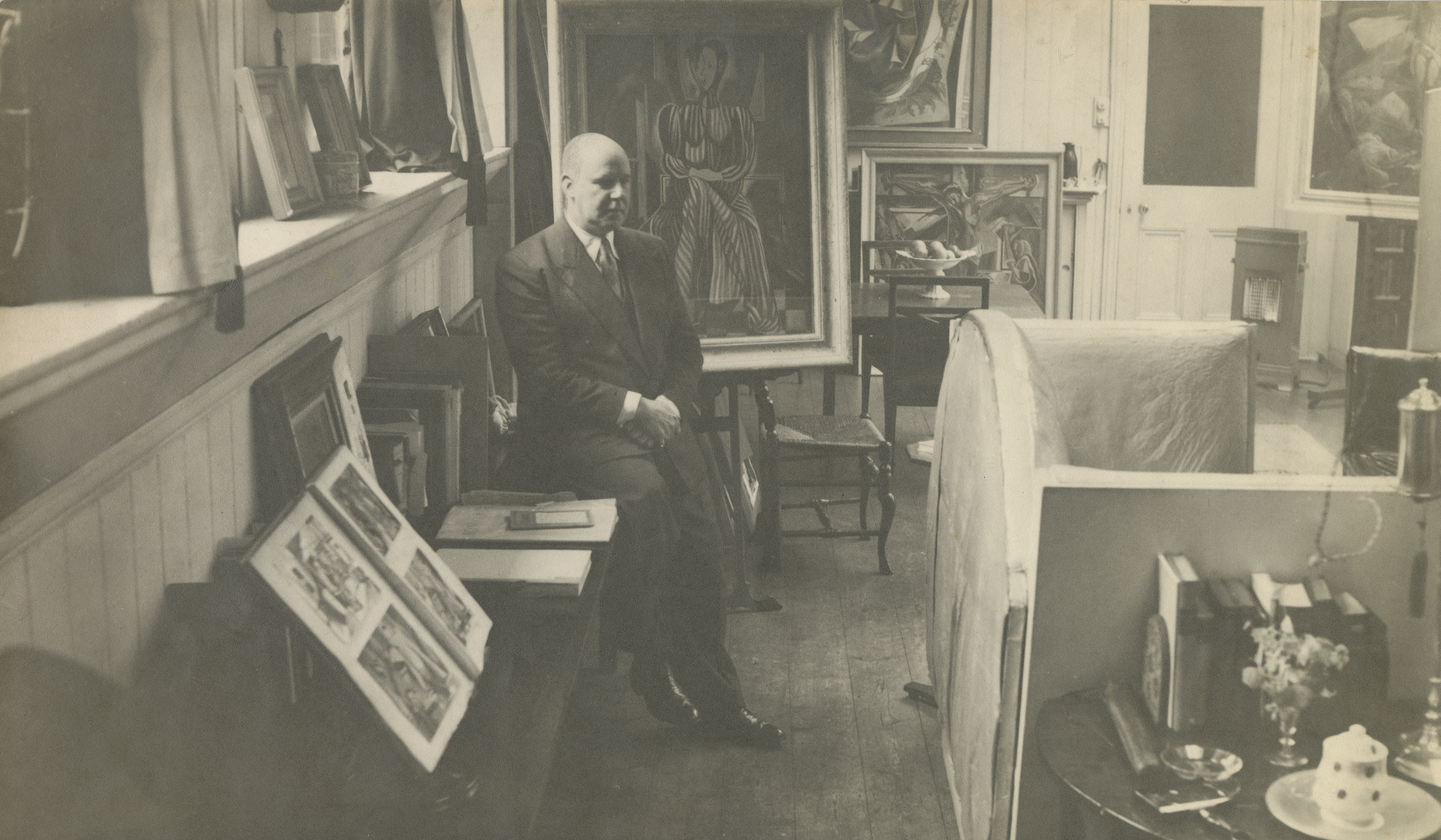 Roy de Maistre in his studio at 13 Eccleston Street, showing the back of the Francis Bacon sofa, c.1944