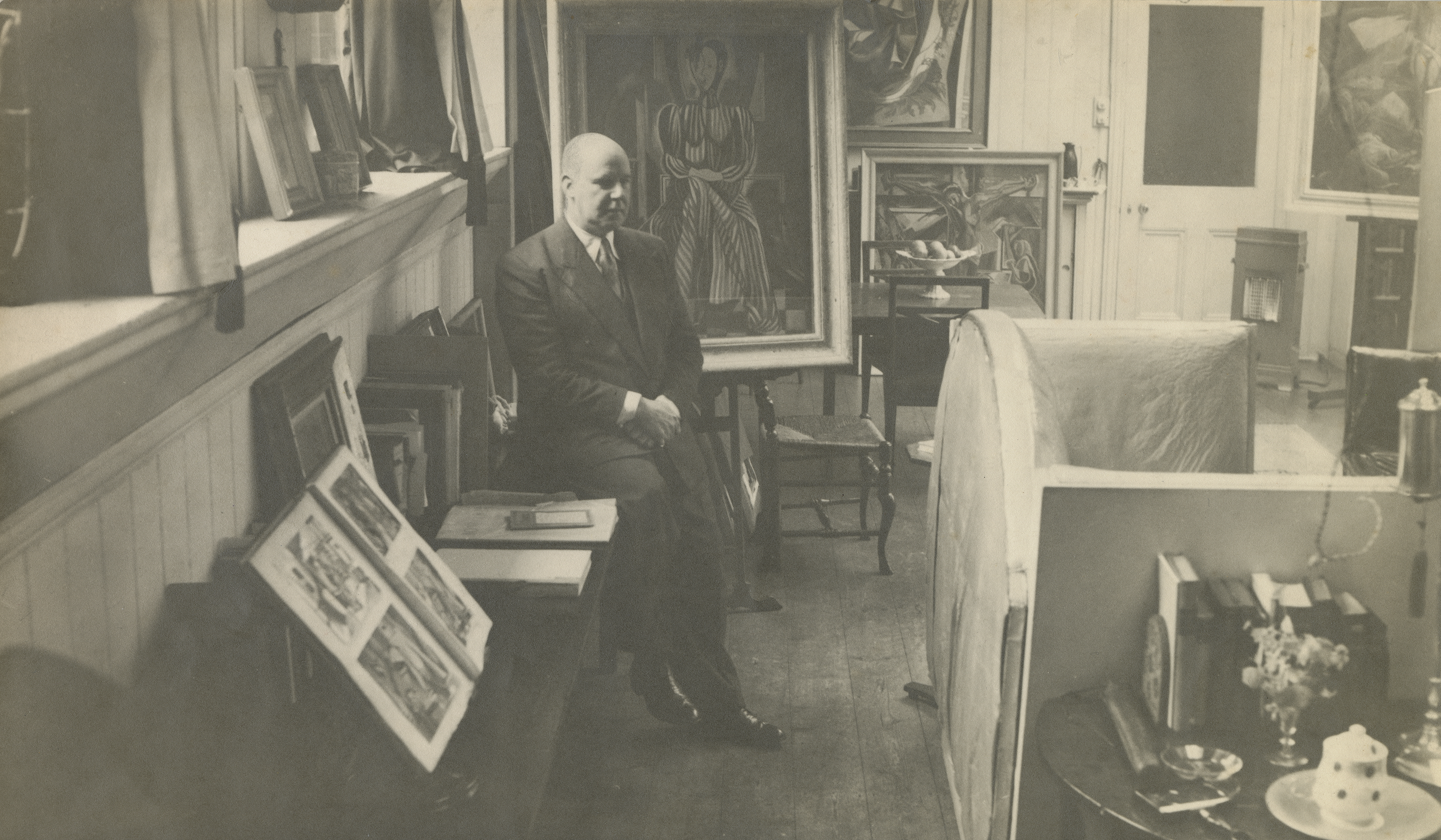 Roy de Maistre in his studio at 13 Eccleston Street, showing the back of the Francis Bacon sofa, c.1944 