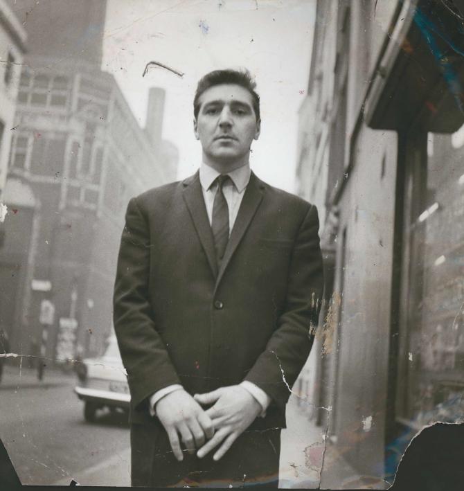Photograph of George Dyer standing on a street in Soho, by John Deakin
